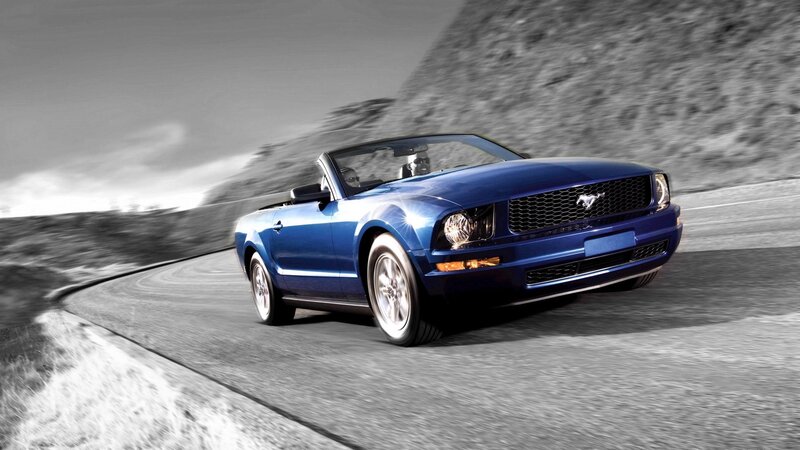 blue mustang convertible on road