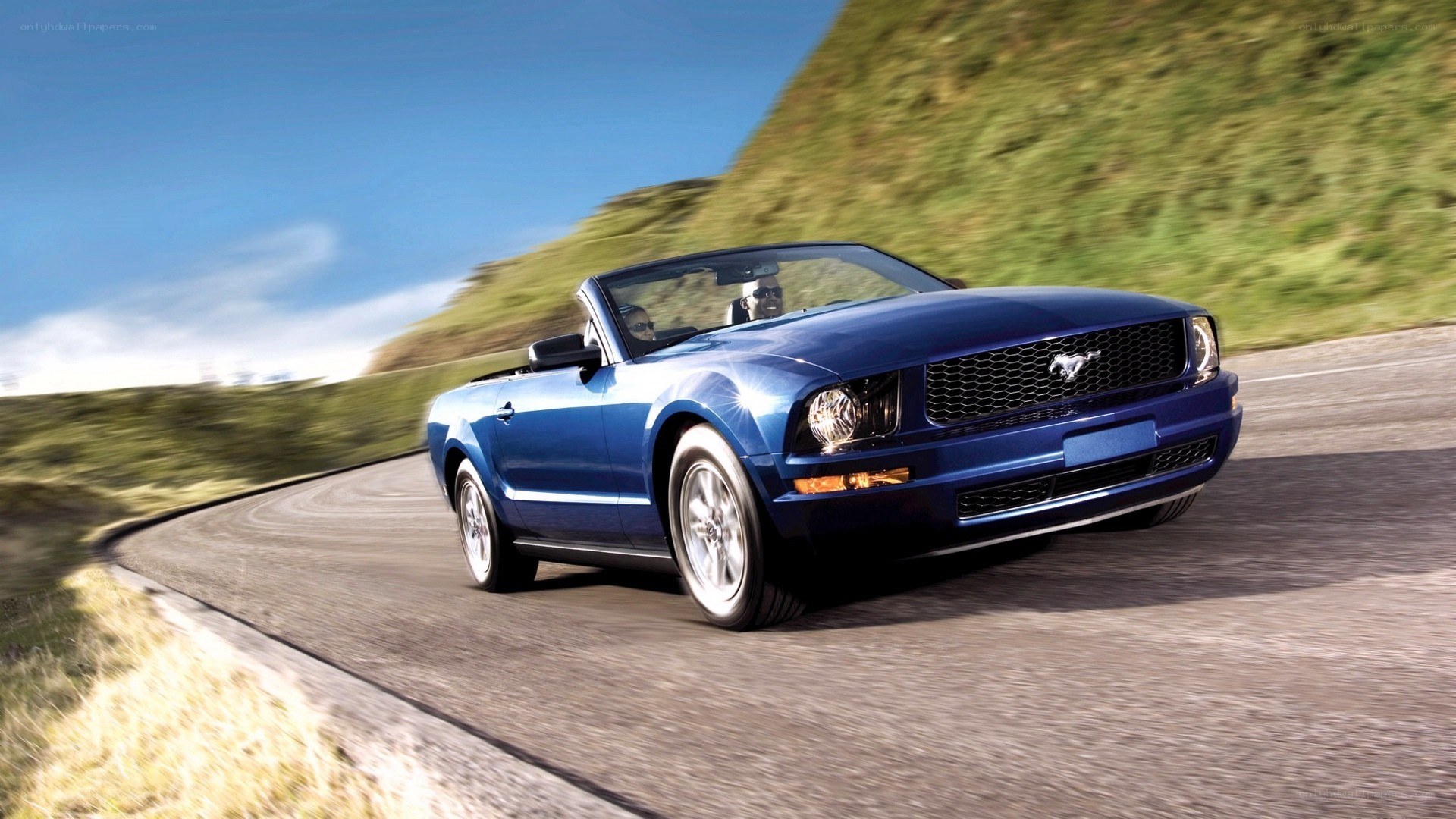 blue mustang convertible on road
