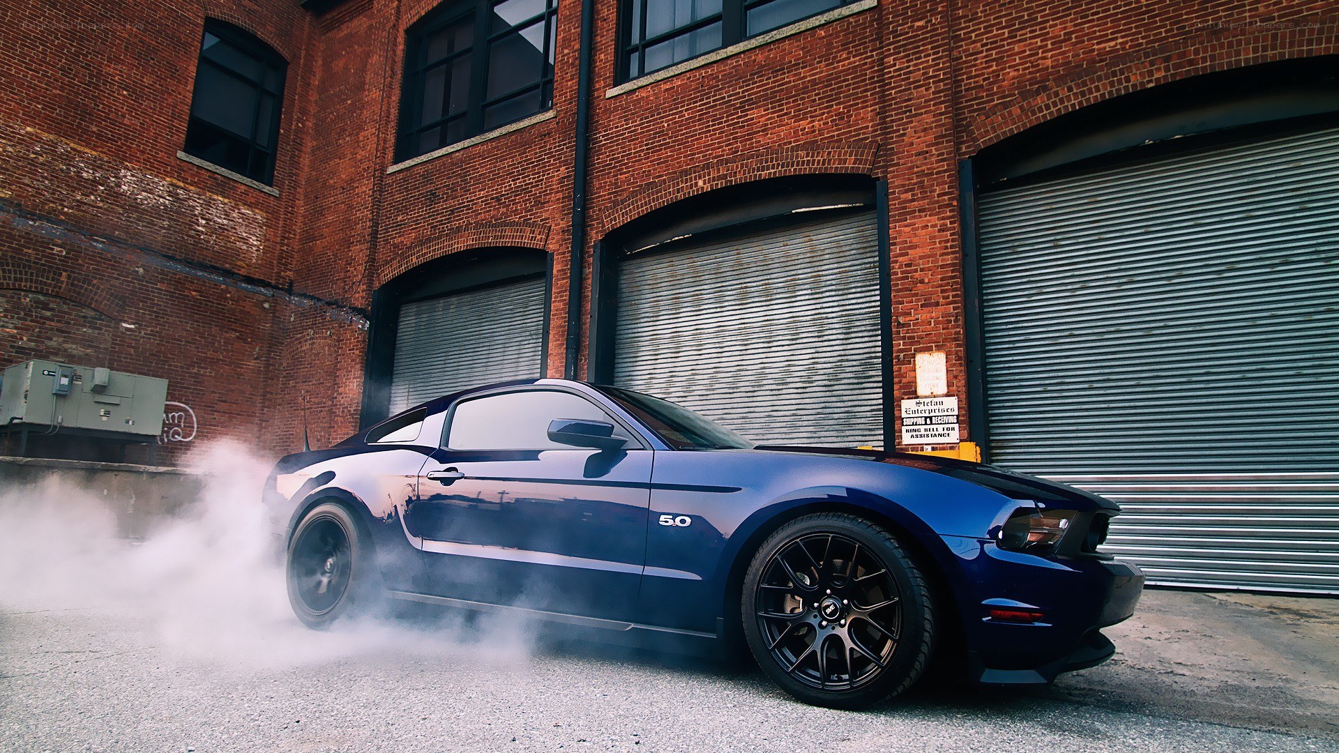 blue mustang doing burnout