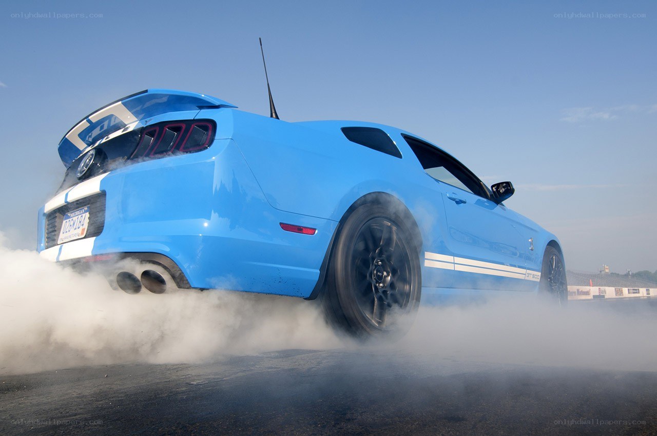 blue mustang doing burnout