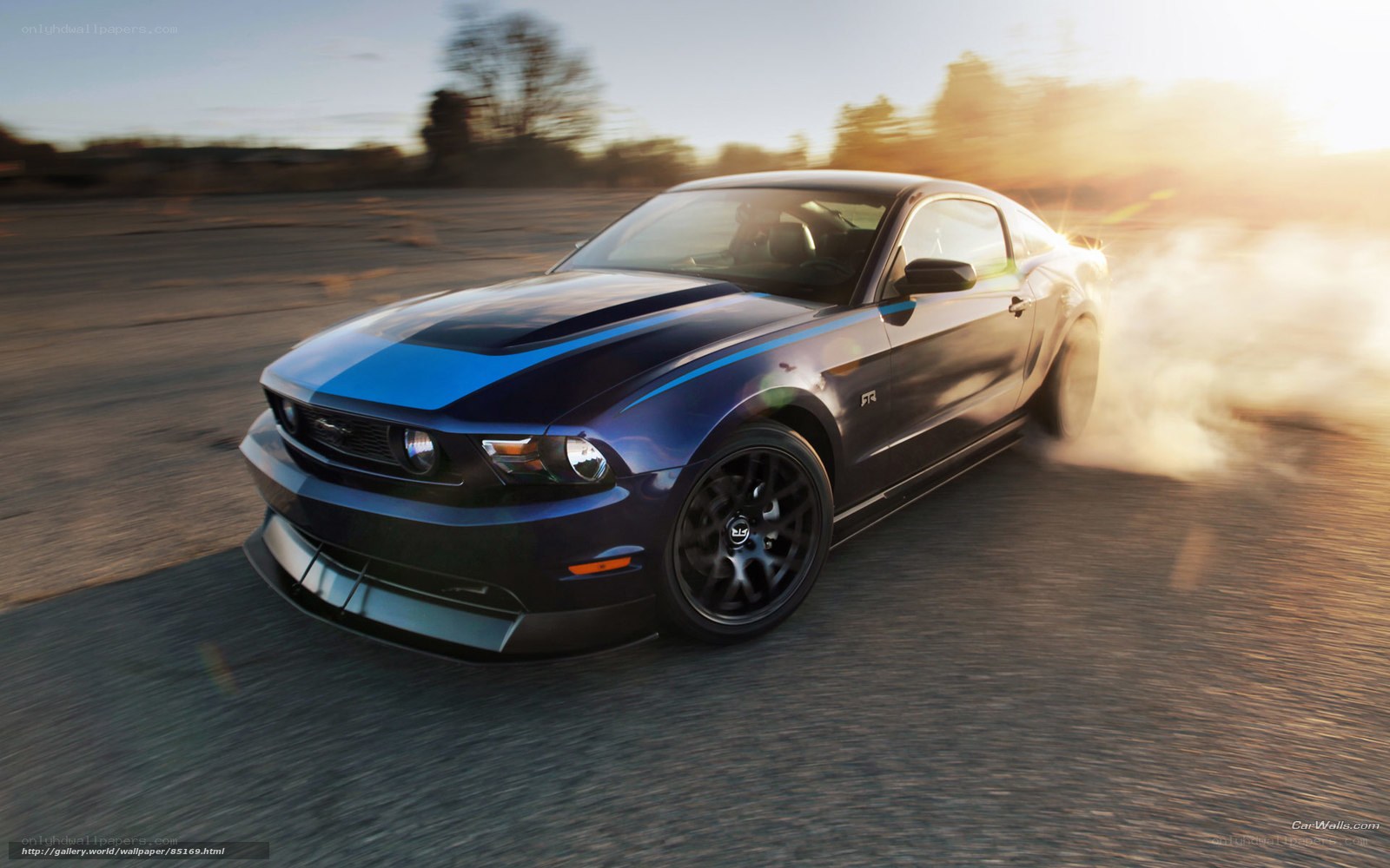 blue mustang drifts at sunset