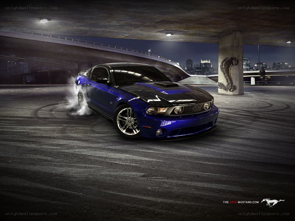 Blue Mustang drifts under overpass