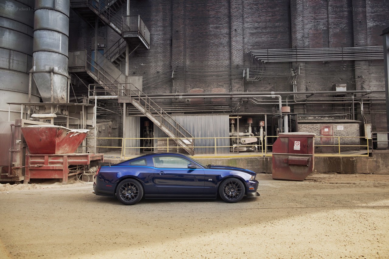 Blue Mustang in industrial setting