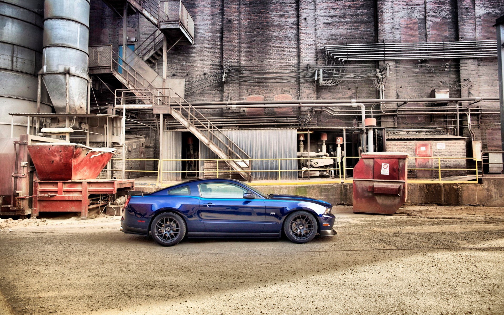 Blue Mustang in industrial setting