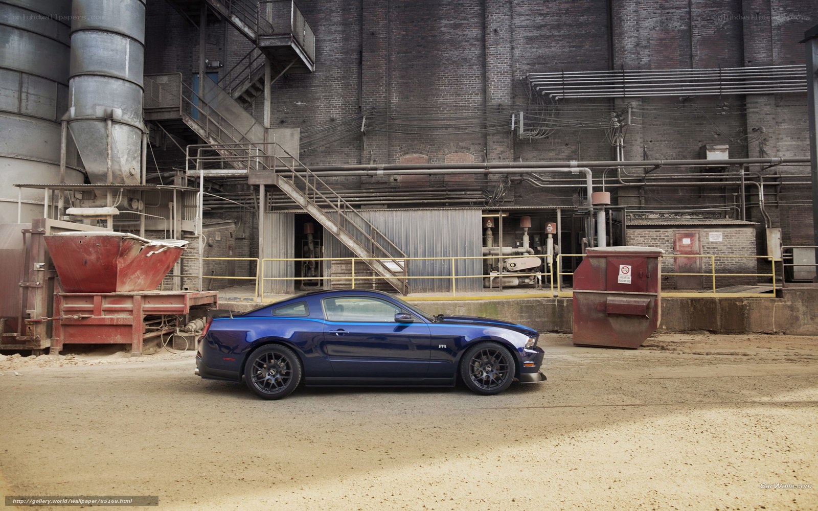 blue mustang in industrial setting