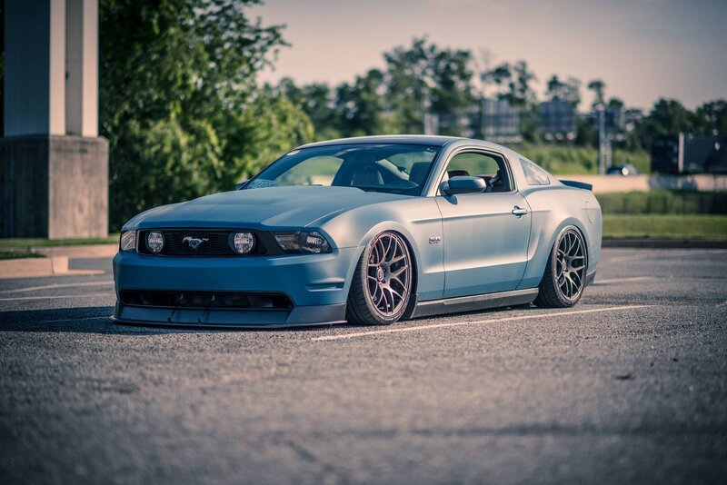 blue mustang on asphalt