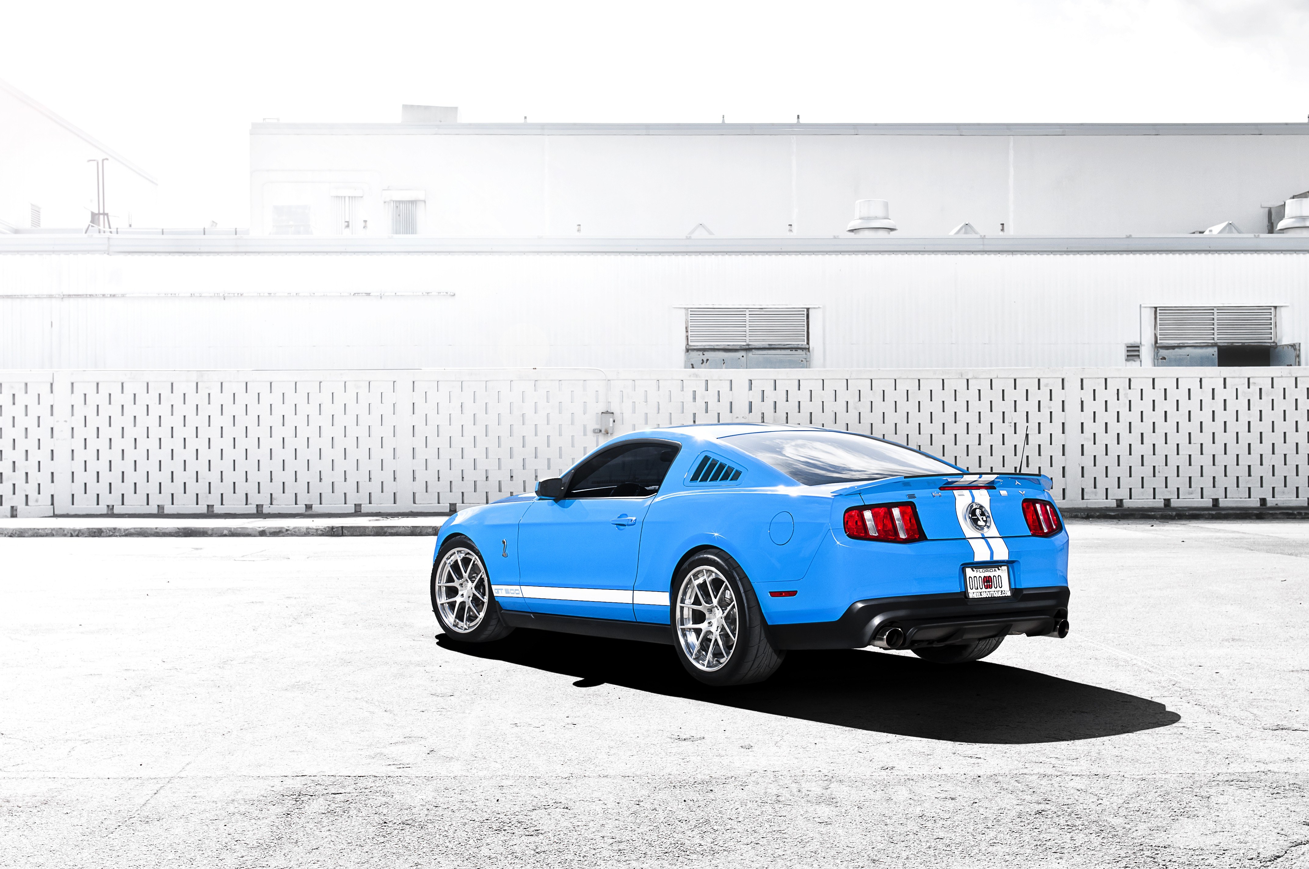 blue mustang on concrete