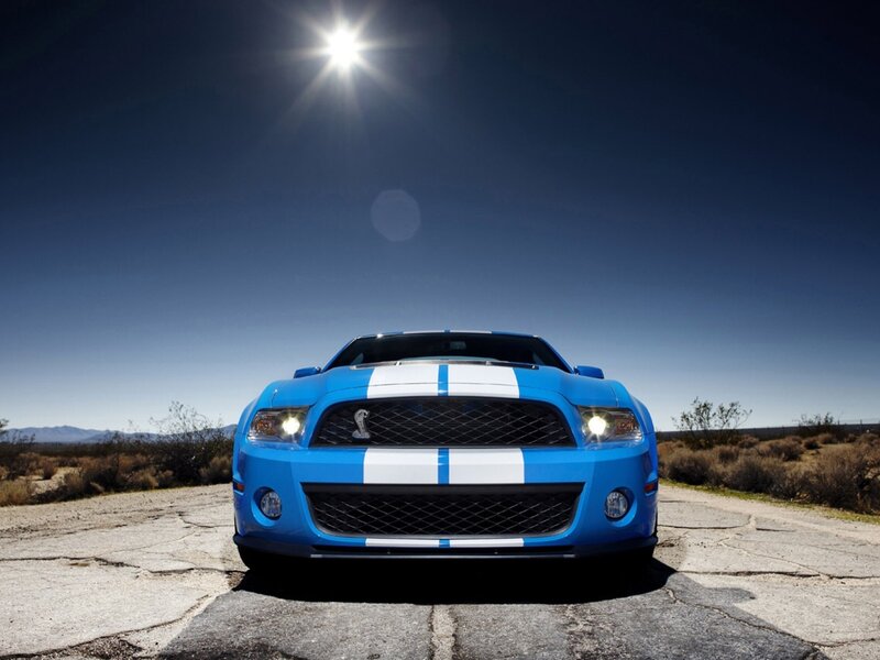 blue mustang on desert road