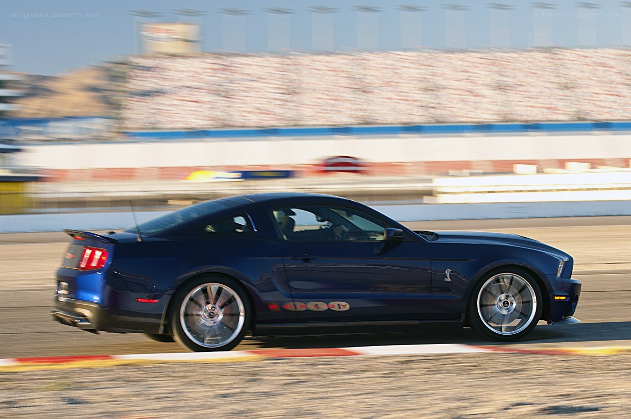 blue mustang on racetrack
