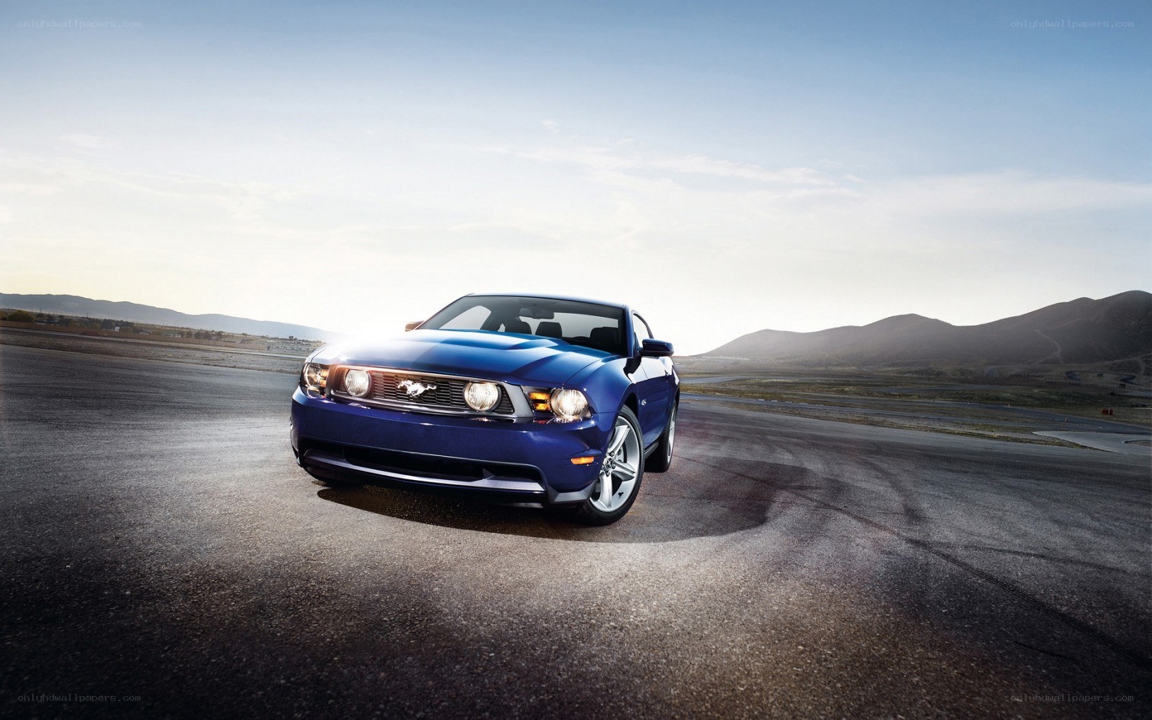 blue mustang on racetrack
