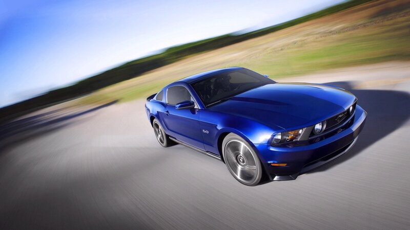 blue mustang on road