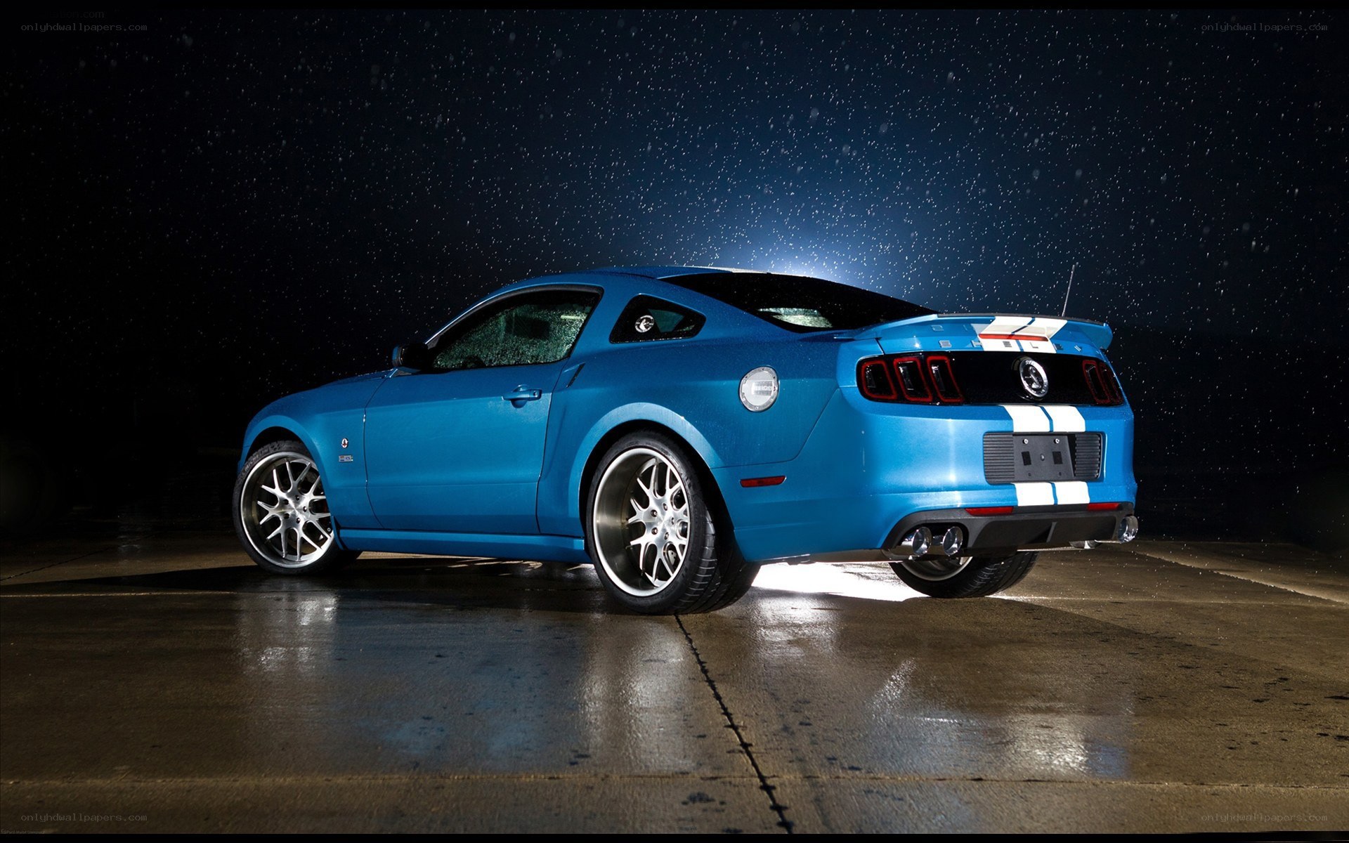 blue mustang on wet pavement