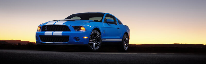 blue mustang shelby at sunset