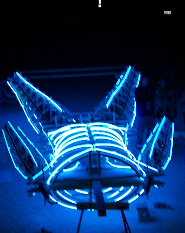 blue neon sculpture at night