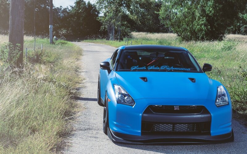 Blue Nissan GT-R on a country road