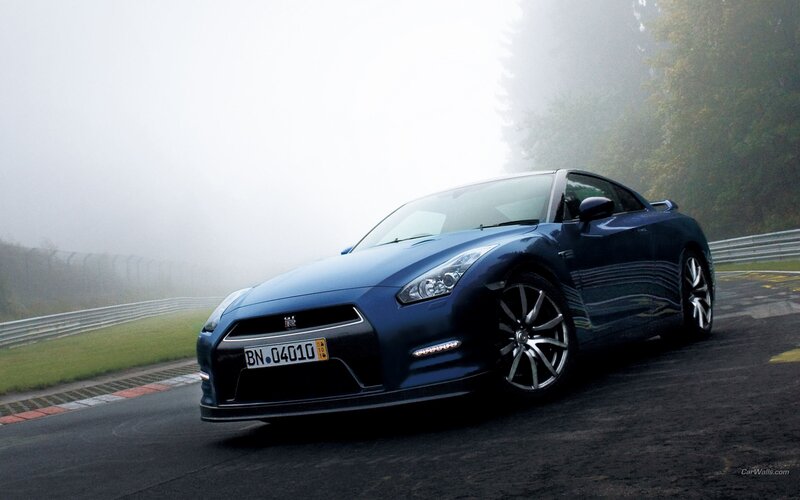 Blue Nissan GT-R on a foggy track