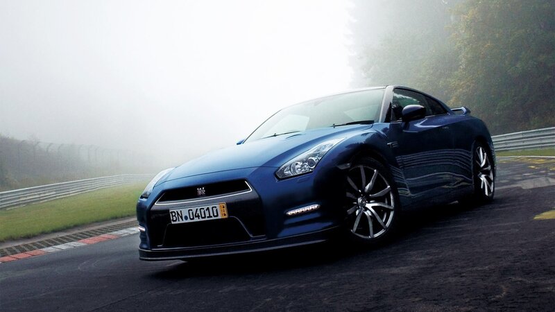 Blue Nissan GT-R on a foggy track