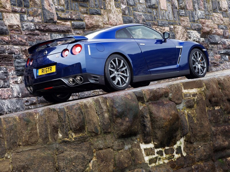 Blue Nissan GT-R on stone wall