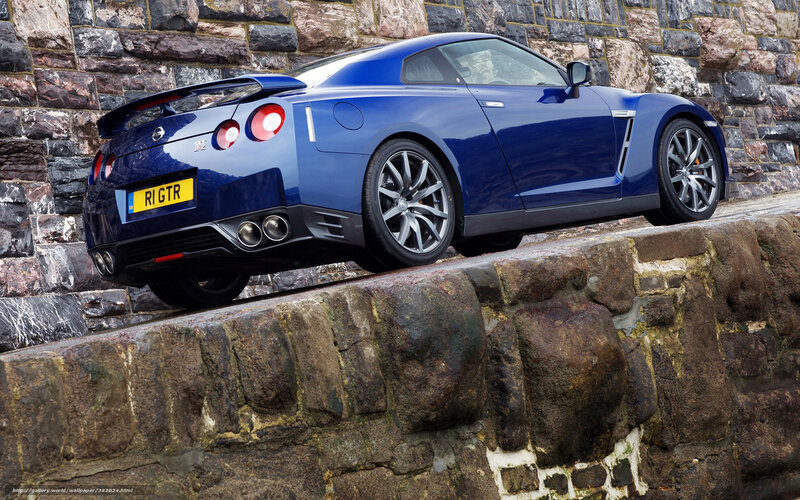 Blue Nissan GT-R on stone wall