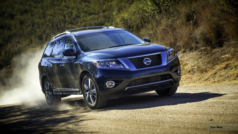 Blue Nissan Pathfinder on dirt road