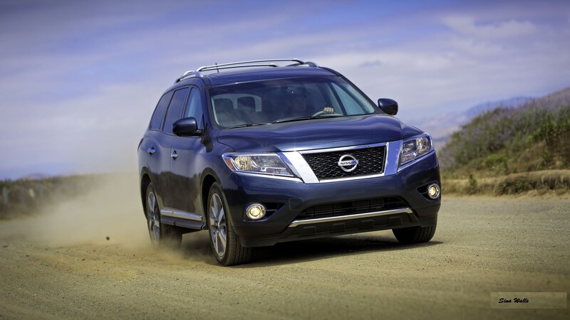 Blue Nissan Rogue on dirt road