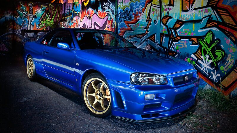 blue nissan skyline in graffiti alley