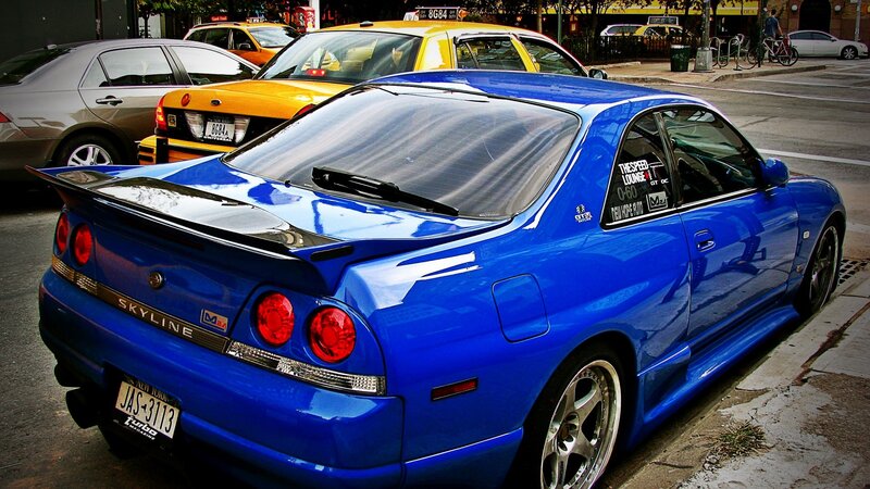 blue nissan skyline parked on street