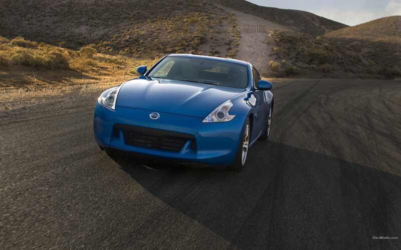 Blue Nissan Z driving on road