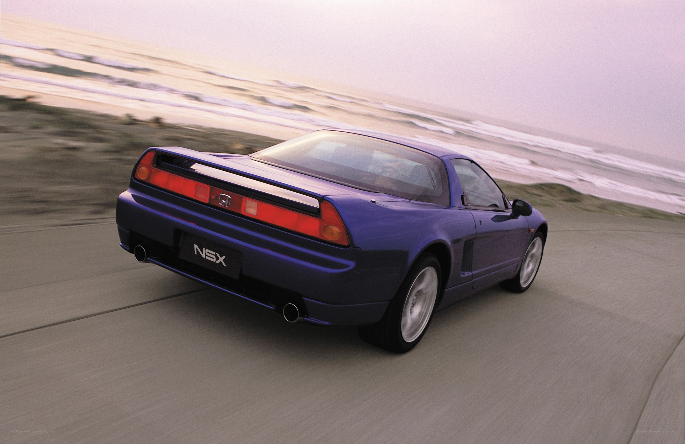 Blue NSX driving on beach road