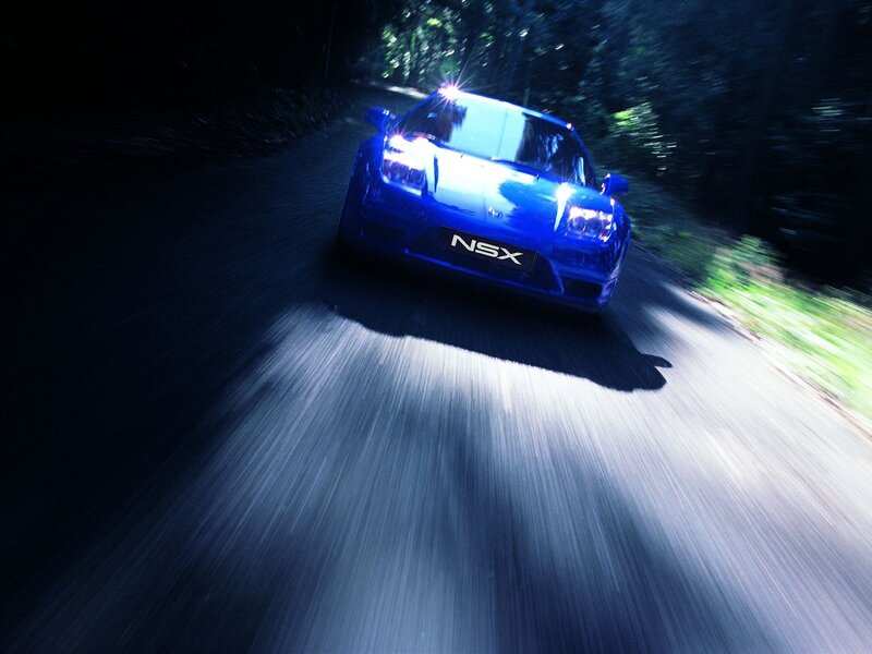 Blue NSX racing on a dark road