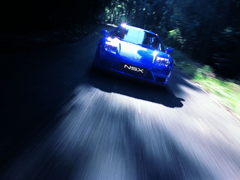 Blue NSX racing on a dark road