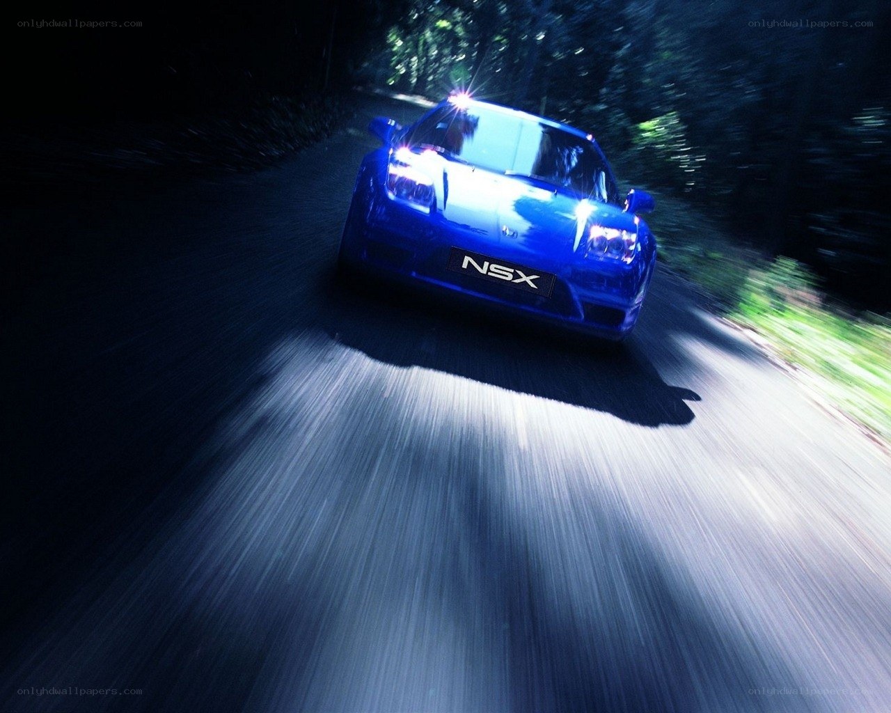 Blue NSX racing on a dark road