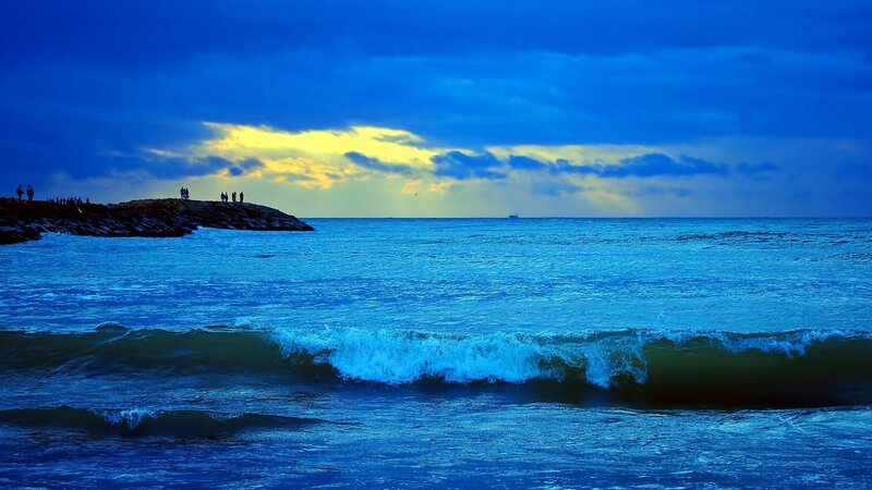 Blue ocean at sunset with waves