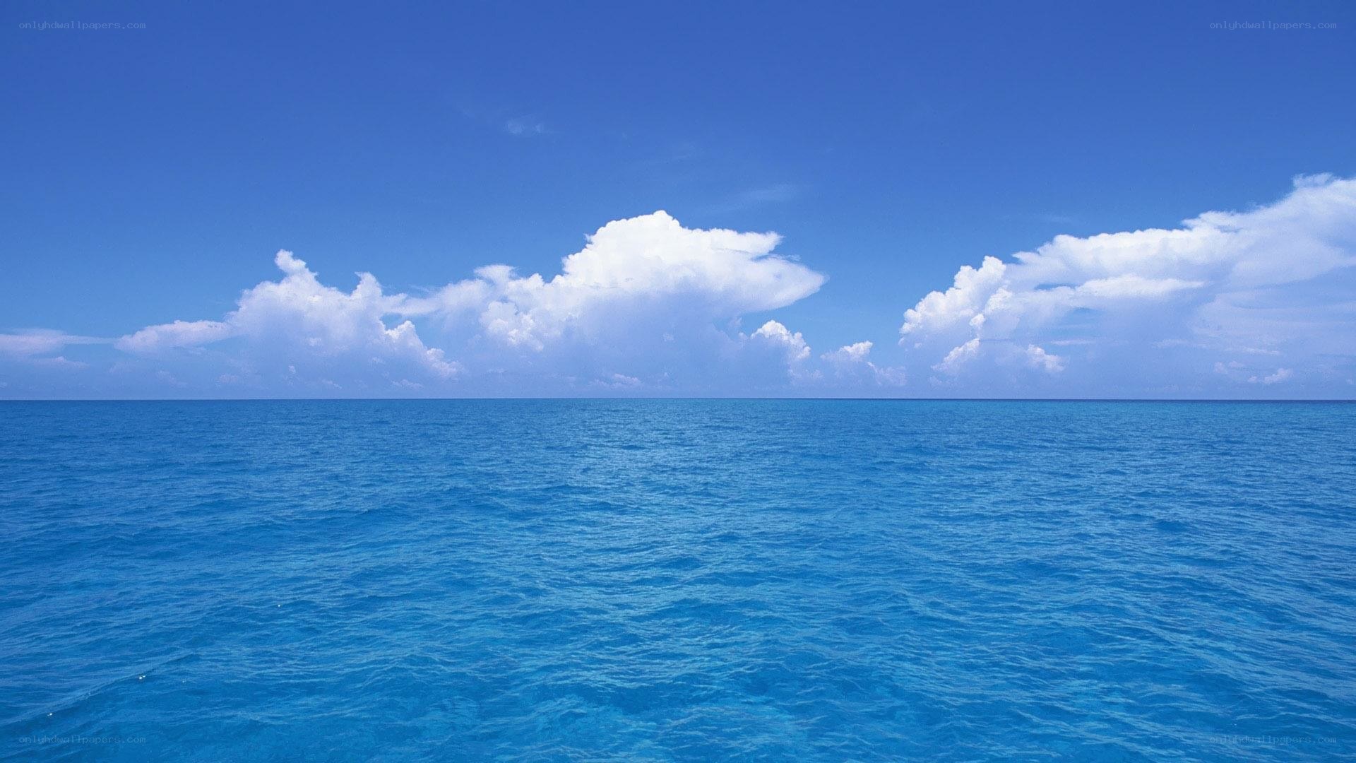 Blue ocean under cloudy sky