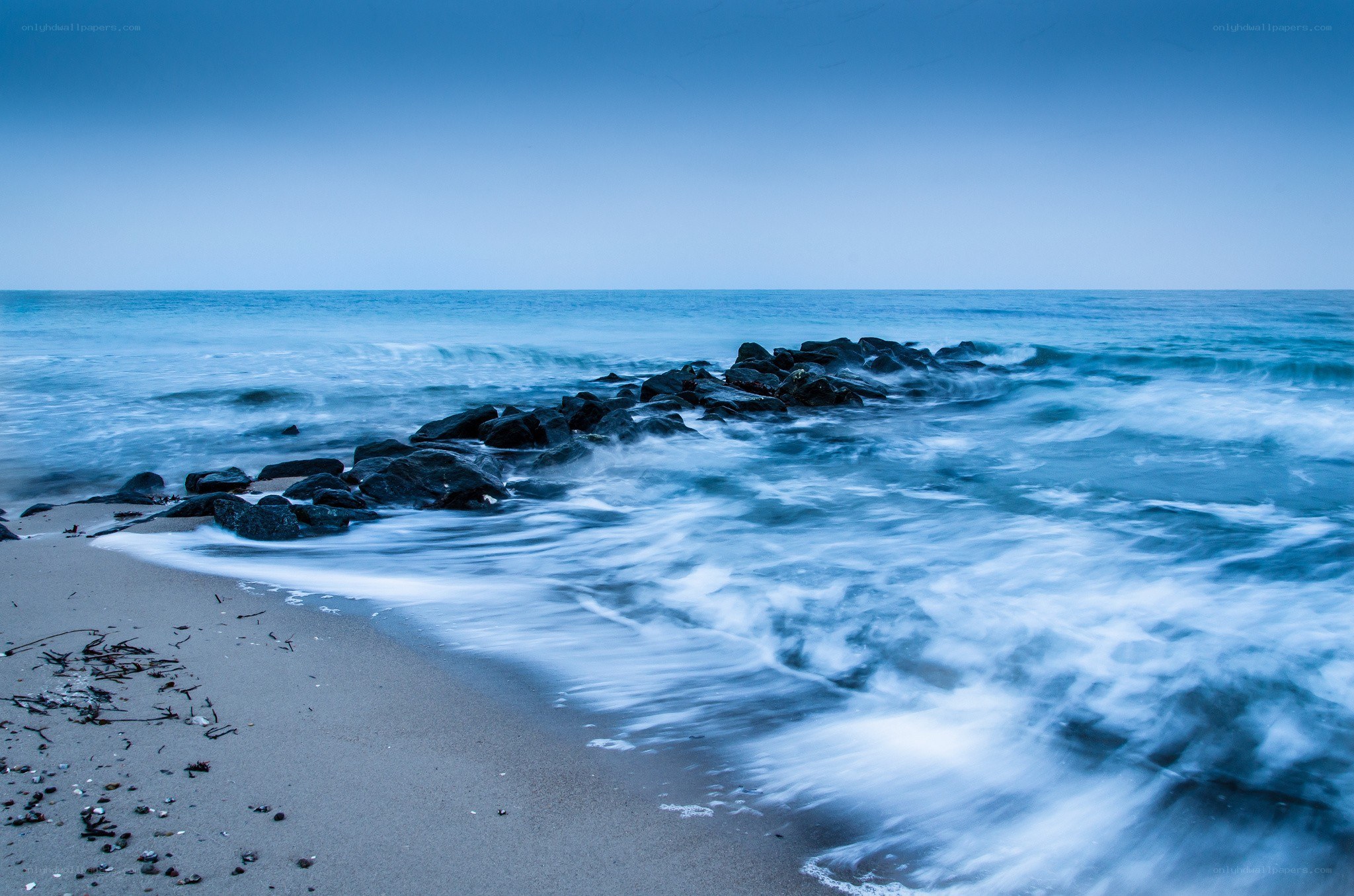 Blue ocean waves at dawn