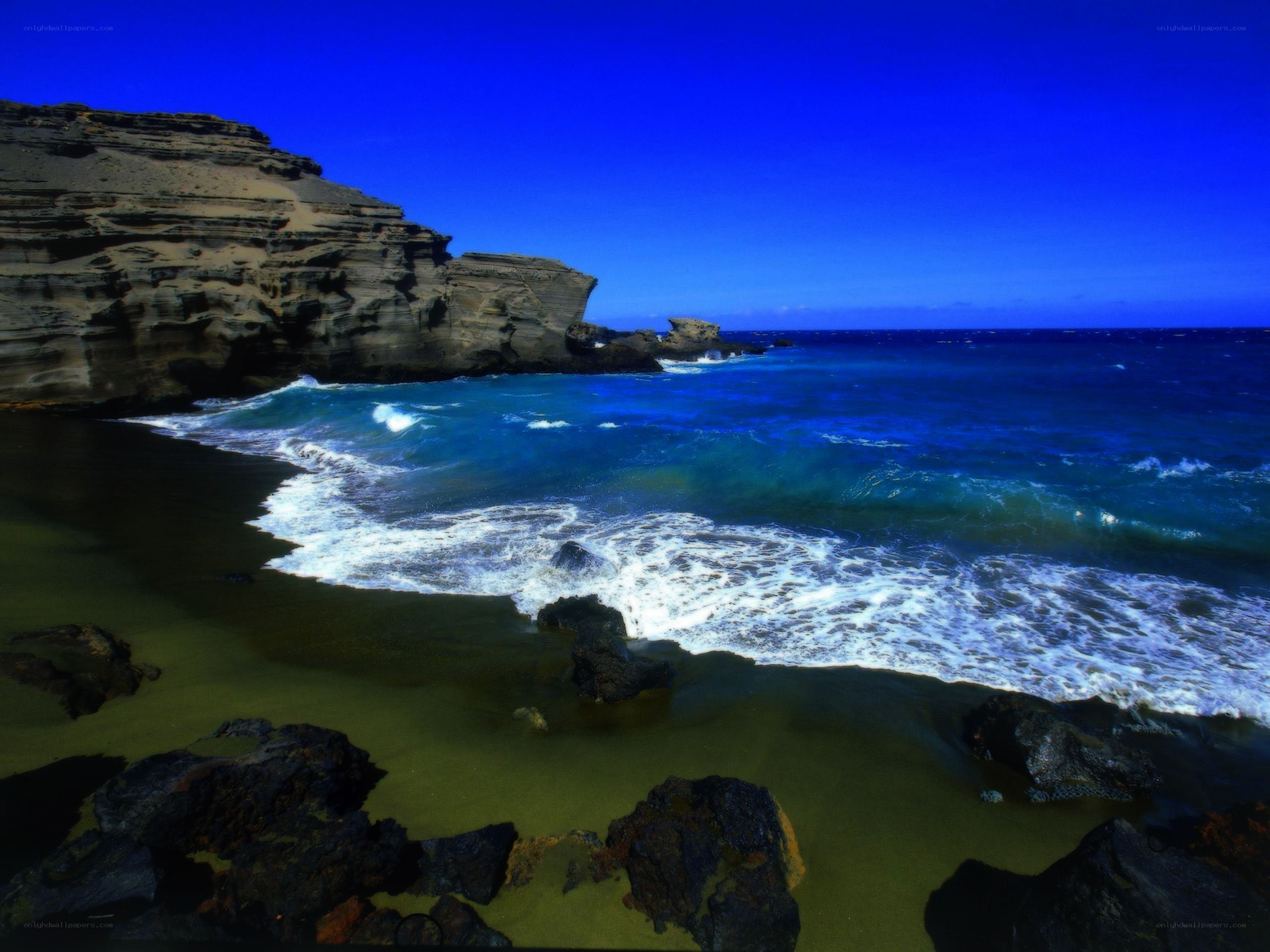 Blue ocean waves at rocky beach