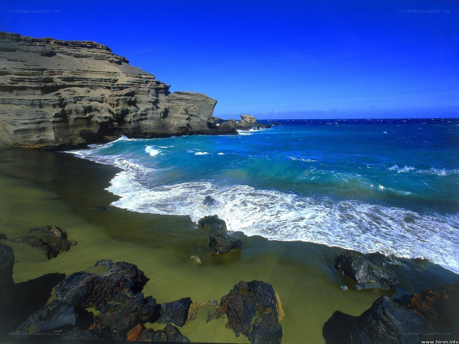 Blue ocean waves at rocky beach