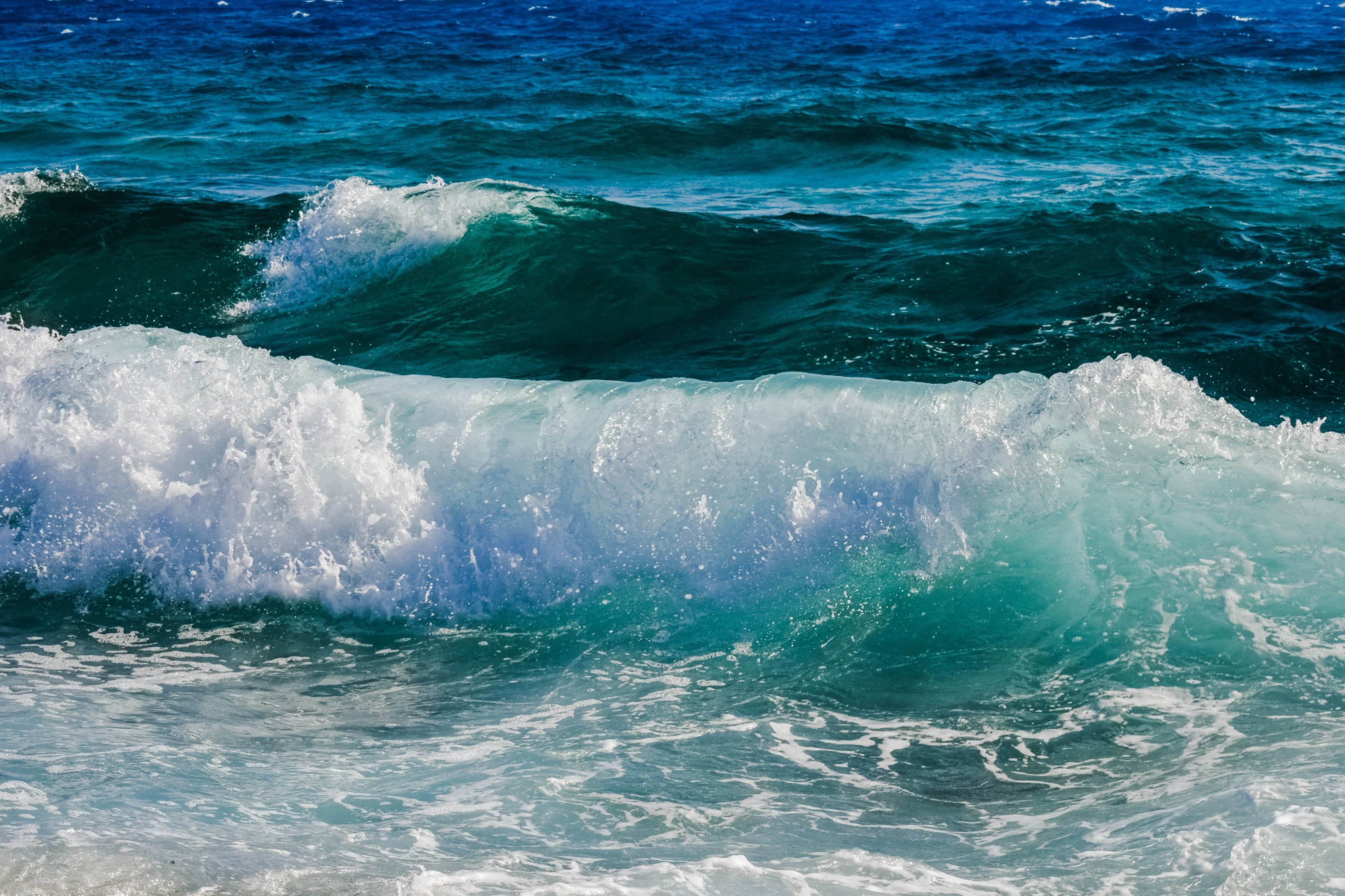 Blue ocean waves crashing