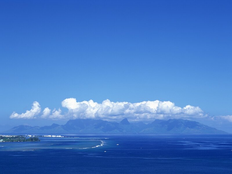 Blue ocean with distant mountains