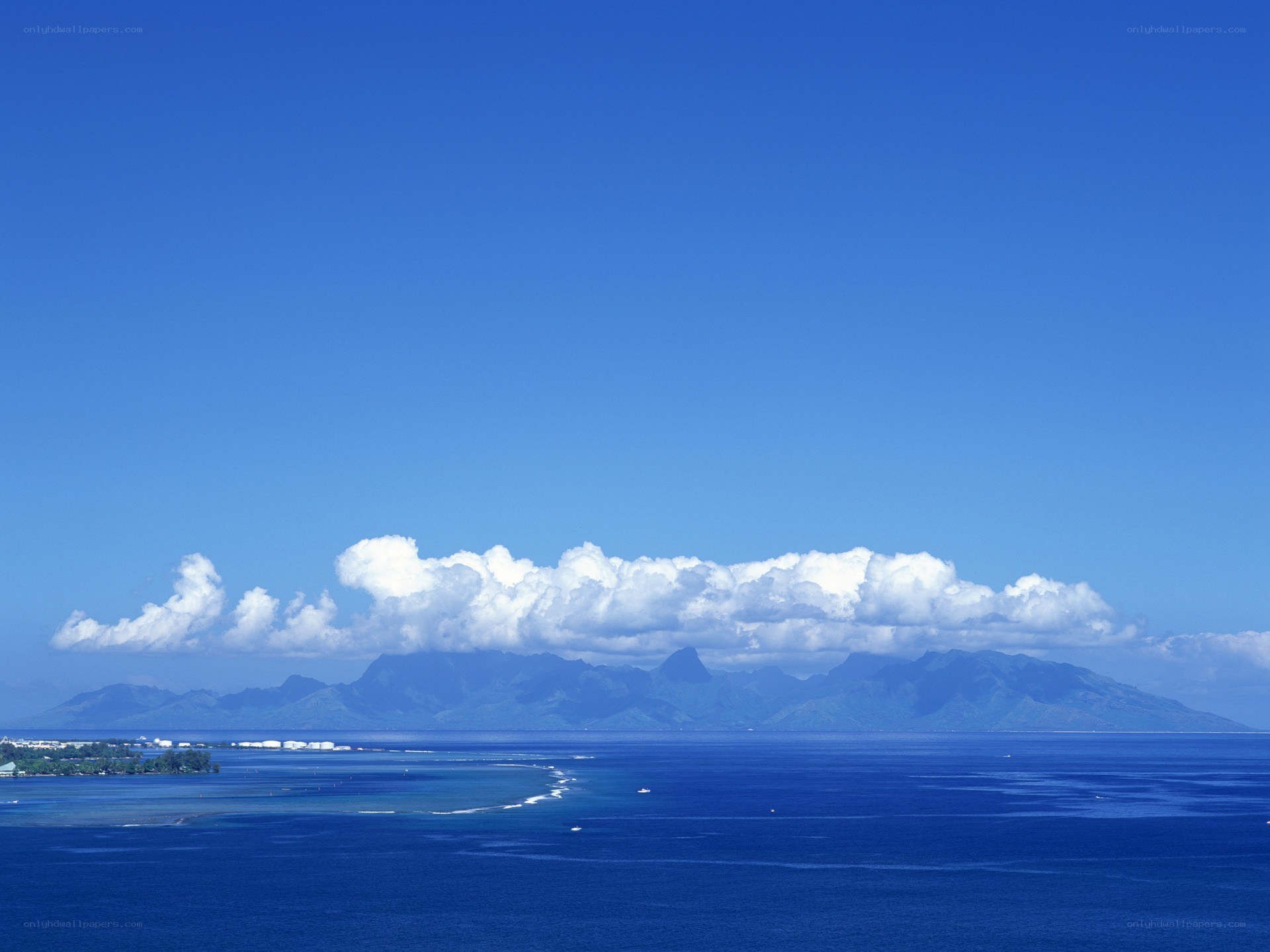 Blue ocean with distant mountains