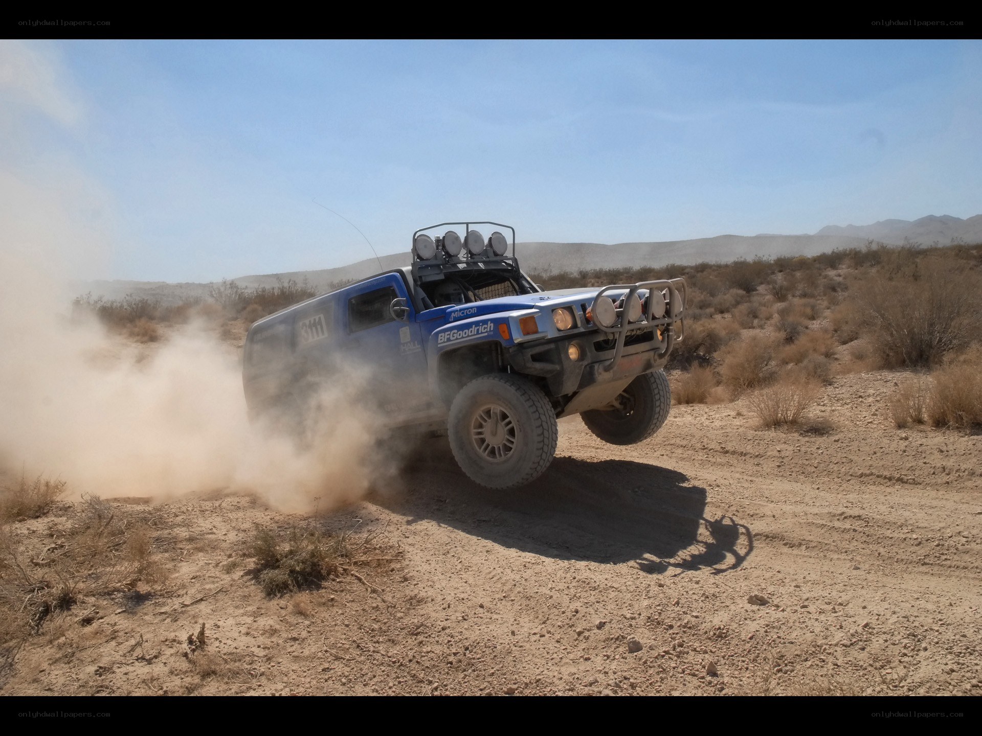 Blue off-road vehicle in desert