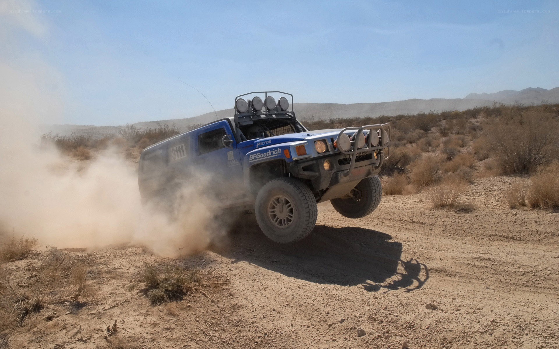 Blue off-road vehicle racing