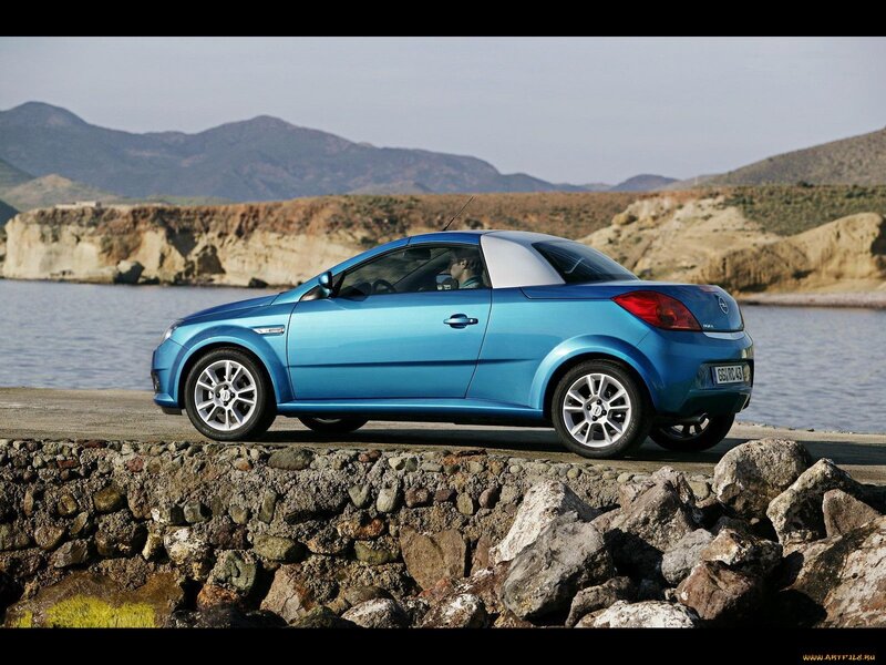 Blue Opel Astra Cabriolet by the coast