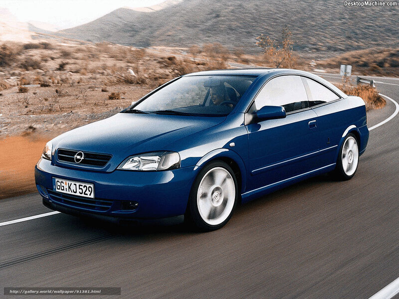 blue opel astra coupe on road