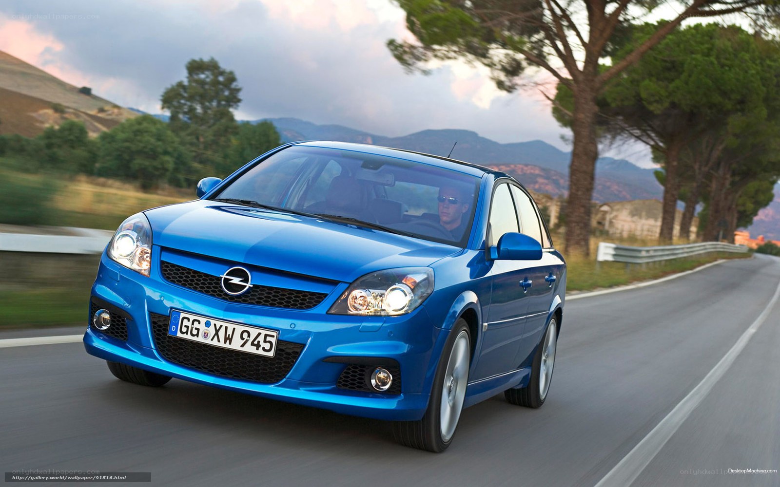 blue opel astra driving on road