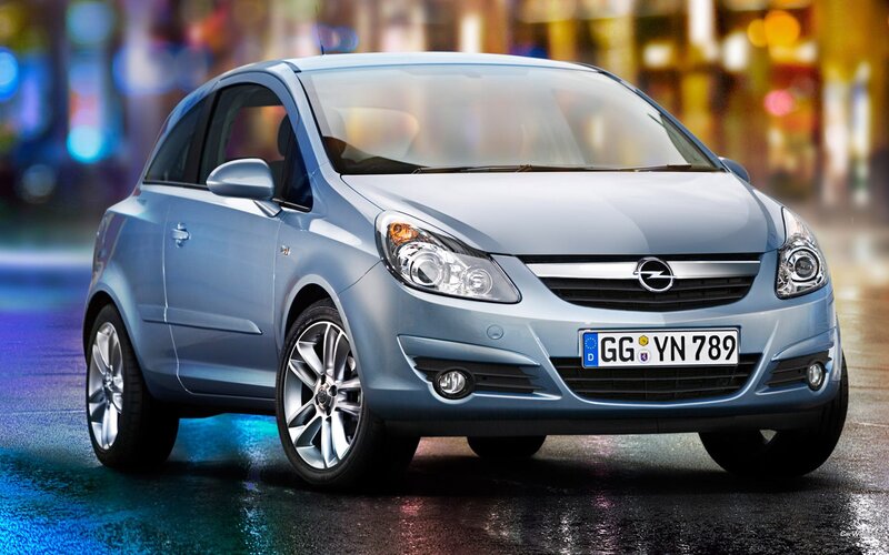 Blue Opel Corsa on wet street
