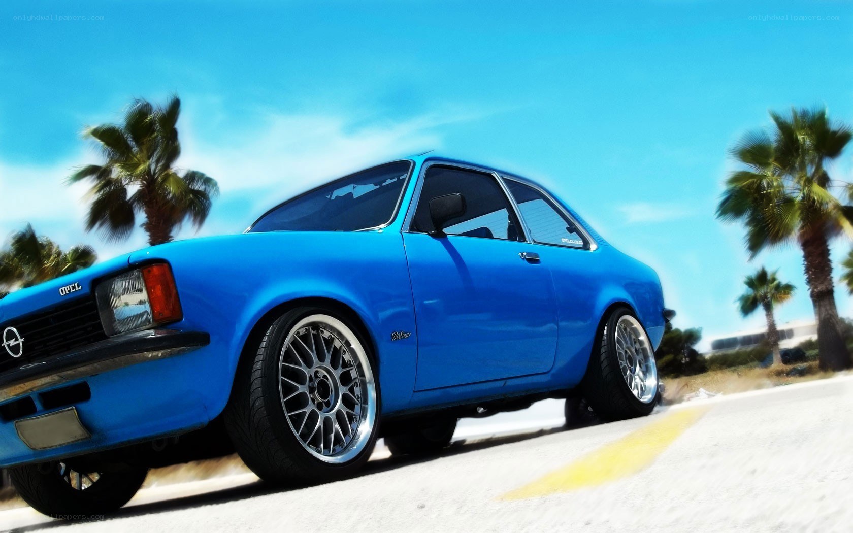 Blue Opel driving on road