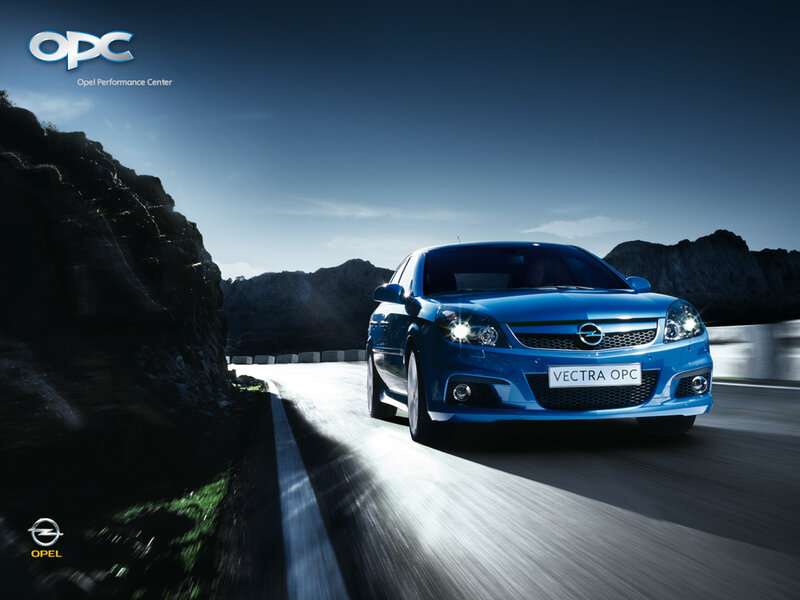 Blue Opel Vectra OPC on mountain road