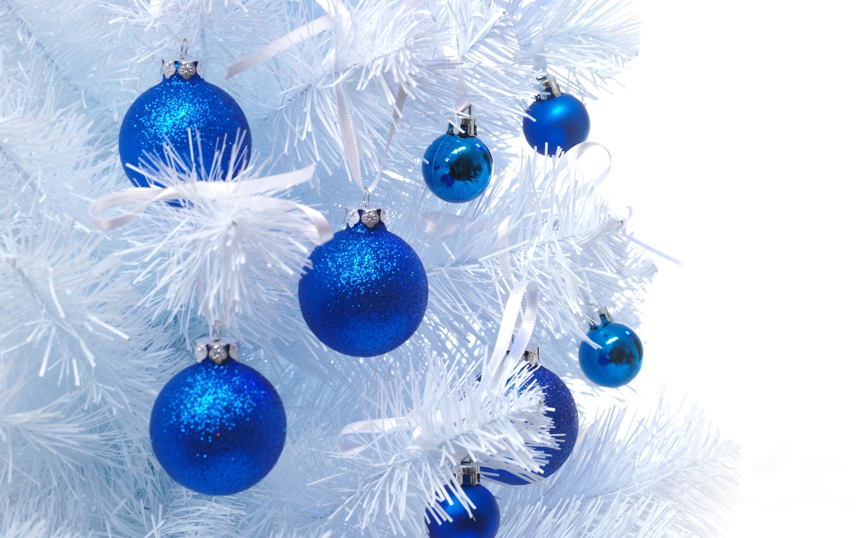 blue ornaments on white tree