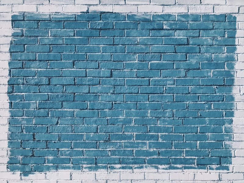 blue paint on brick wall